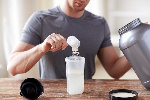 Man Making Shake with Protein Powder