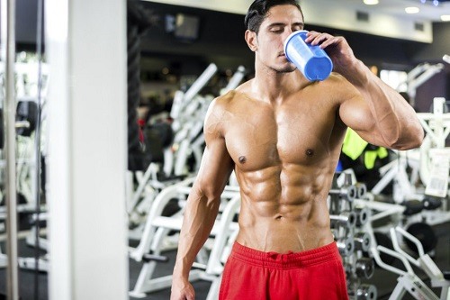 Man in Gym Drinking Pre Workout Supplement Shake