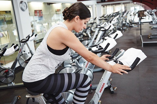 Woman In Full Spinning Clothes in a Gym